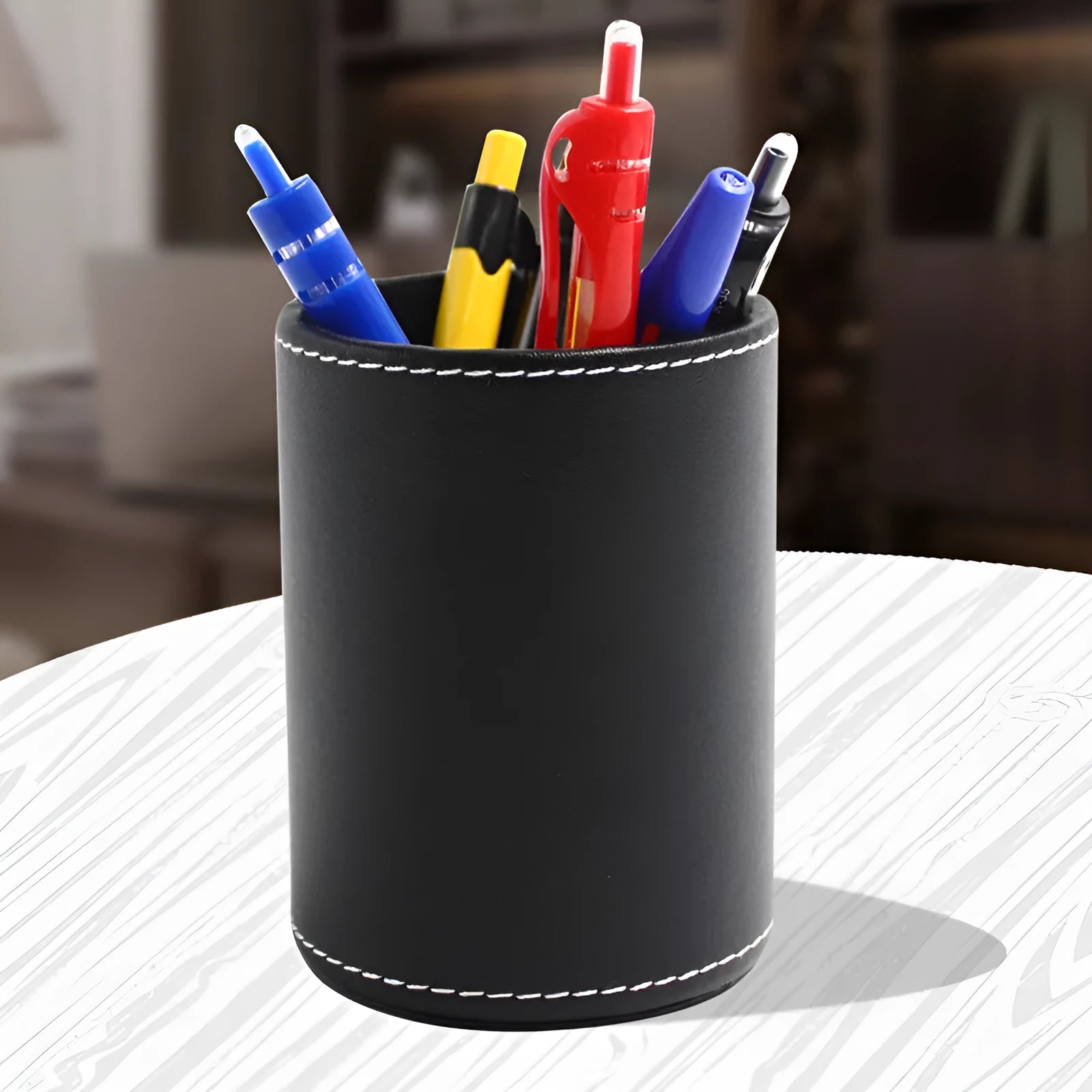 Round black leather pen container showing cylindrical shape and dimensions
