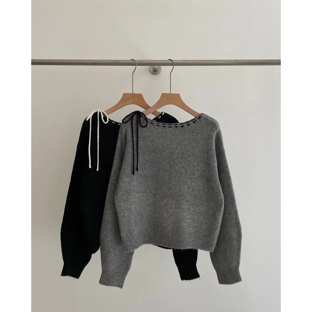 Women's loose grey knitwear pullover showing front view and relaxed fit