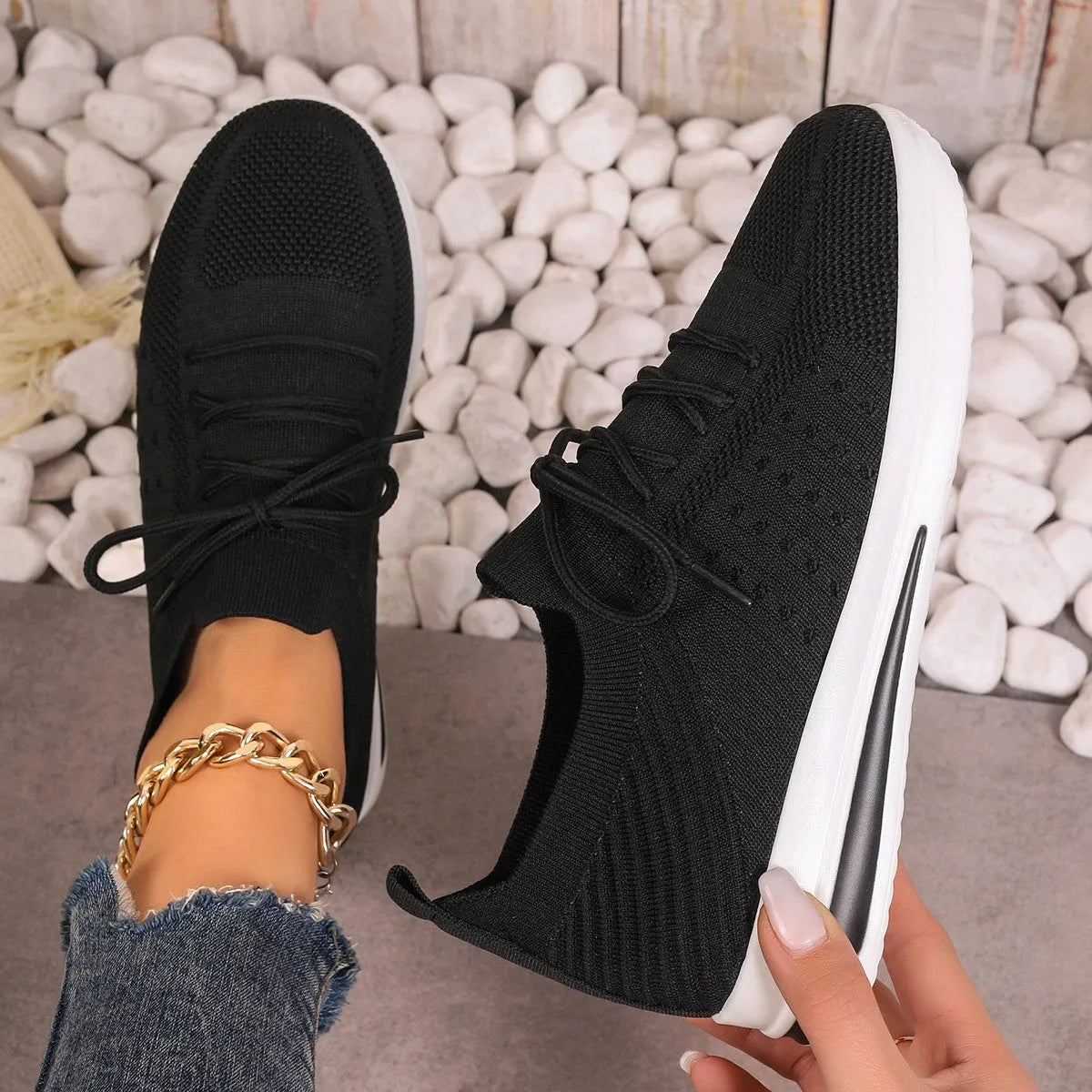 Women's low-top fly-knit sneakers in red with front lace-up closure and round toe.