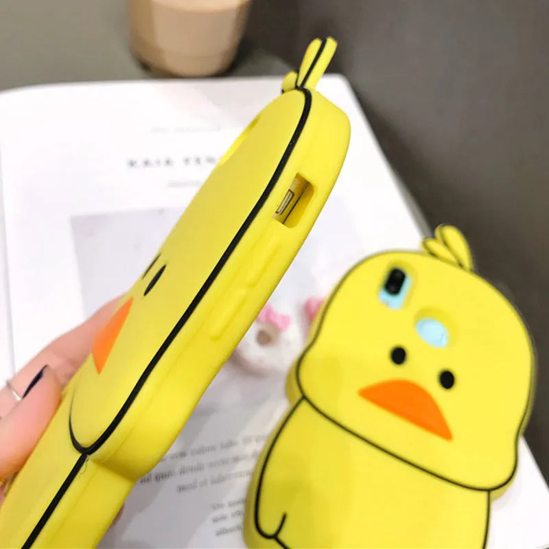 Green and yellow silicone phone cases with cartoon animal designs for Apple iPhones.