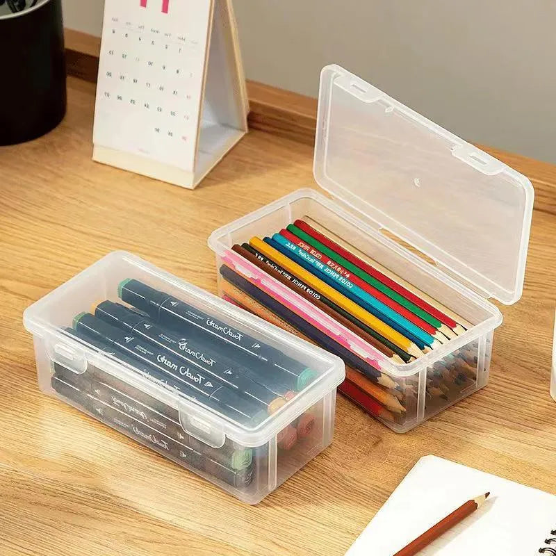 Transparent plastic stationery storage box with pencils and crayons inside
