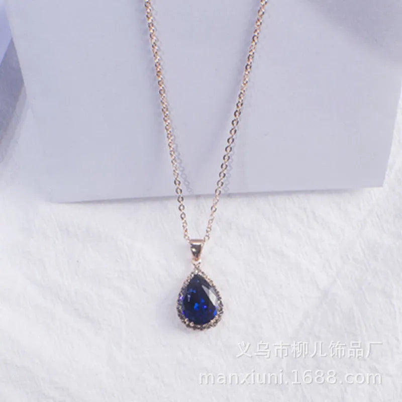 Women's geometric drop shape pendant necklace with rhinestone detail in pink electroplated finish.