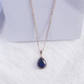 Women's geometric drop shape pendant necklace with rhinestone detail in pink electroplated finish.