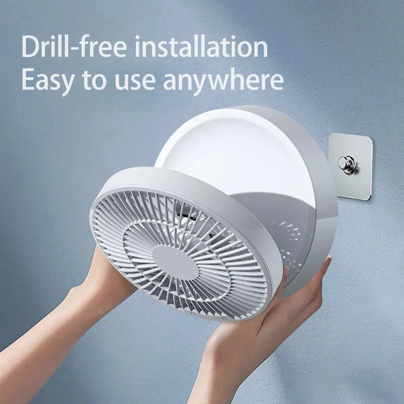 White rechargeable folding USB ceiling fan with remote control on wooden desk