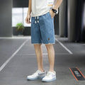Man wearing green Korean-style loose straight-leg casual beach shorts