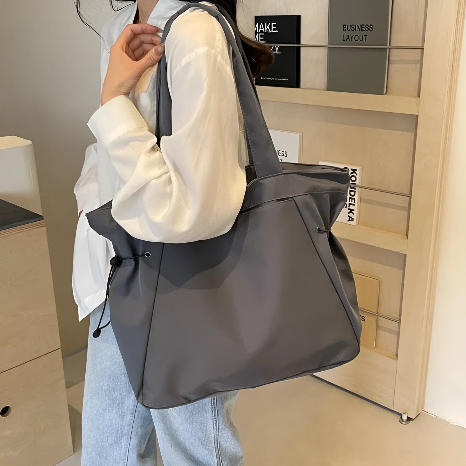 Oxford cloth folding shoulder tote bag in a choice of five colours including black, brown, and purple.