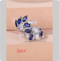 Adjustable copper leaf-shaped ring with zircon gemstone colour options on a white background.