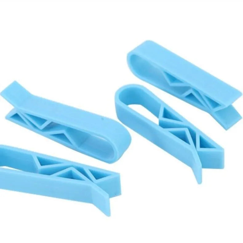 A white polypropylene plastic clip for holding bin bags onto the side of a rubbish bin.