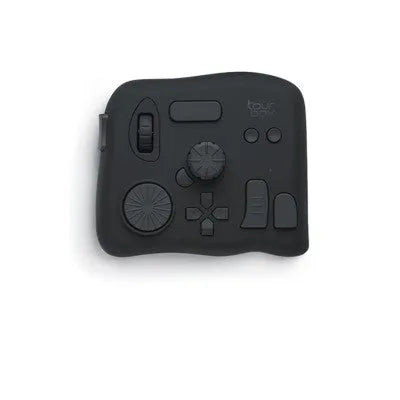 TourBox NEO black USB auxiliary keyboard for video editing on a desk, showing dials and buttons.