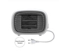 Compact green mini ceramic heater with metal mesh grille on a desk