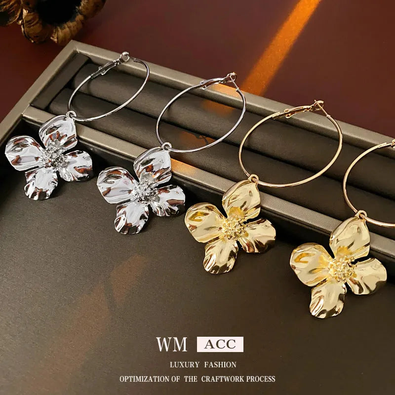 Flower and geometric design metal earrings in gold or silver electroplated finish with silver needle posts