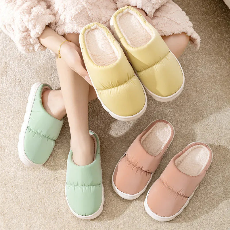 Blue winter slippers for indoor use with a thick rubber non-slip sole and artificial plush lining.