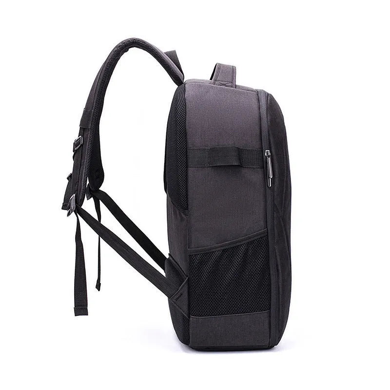 Black Oxford cloth drone backpack showing multiple internal compartments for camera and laptop storage