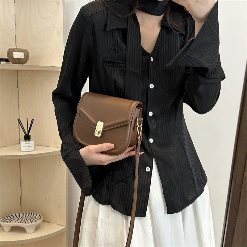 Soft PU leather messenger bag with clamshell opening in a horizontal square shape.