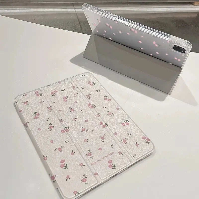 Transparent floral tri-fold iPad case with magnetic stand, showing cartoon print on clear PC hard shell.