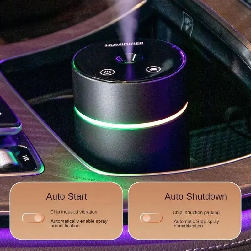 Aluminium portable car air humidifier and essential oil diffuser with multi-colour light on a black USB cable.