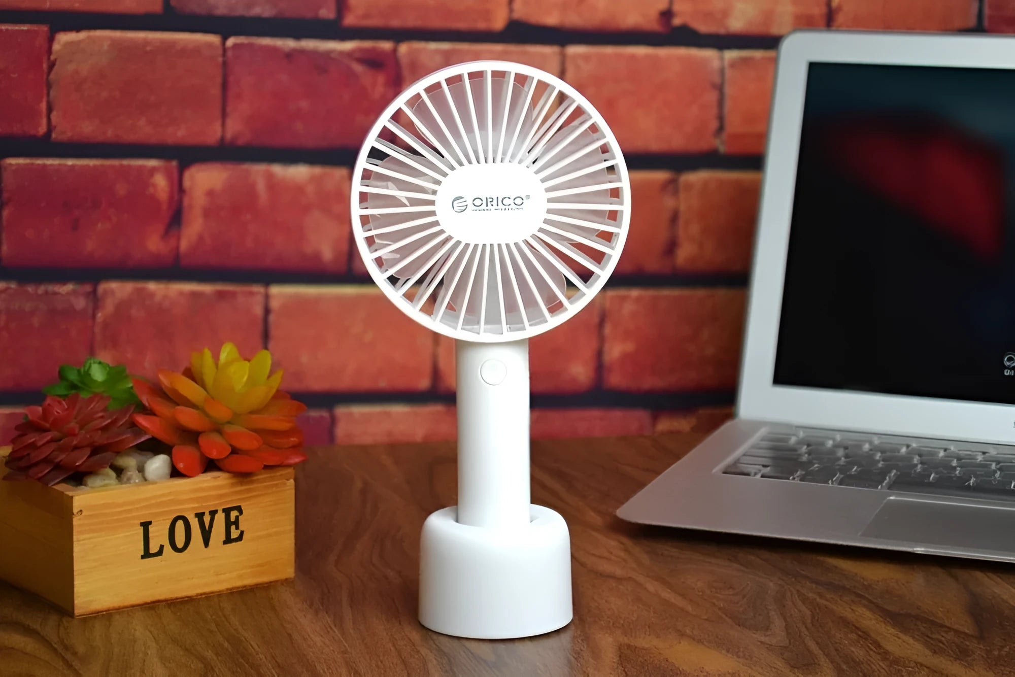 White ORICO FH1 portable USB rechargeable fan with three-speed control on desktop