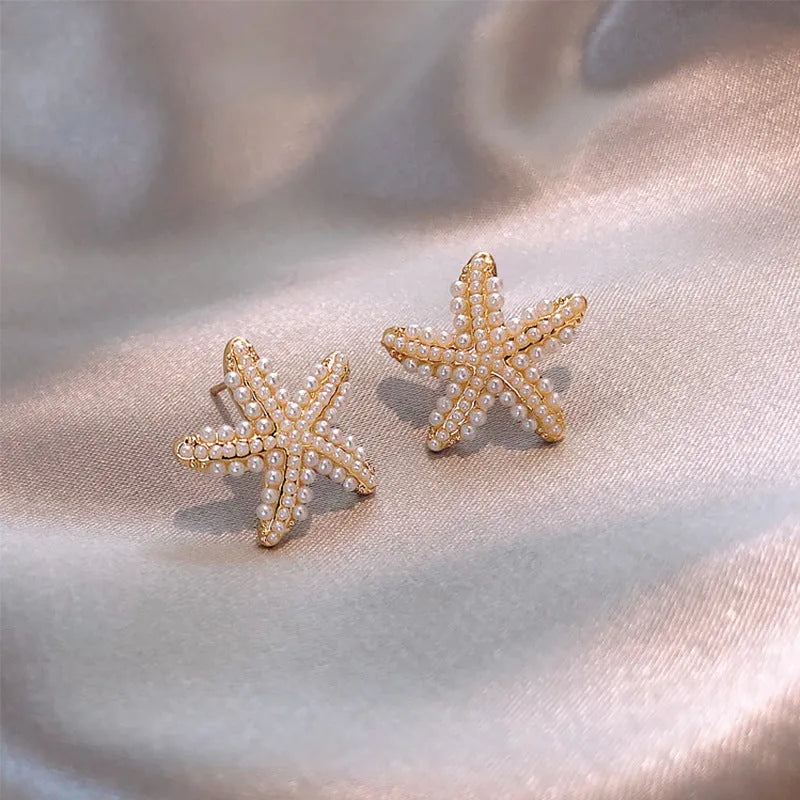 Pineapple and starfish motif drop earrings with pearl and artificial gemstone details on alloy metal