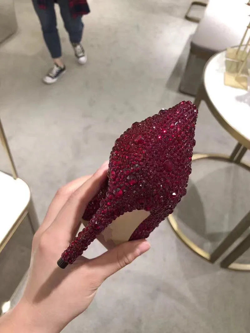 Women's gold high heels with pointed toe, rhinestone decoration, and stiletto heel