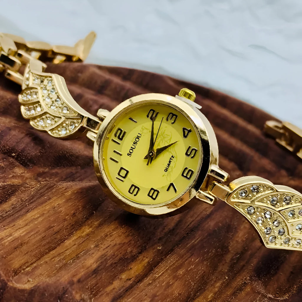 Women's stainless steel watch with round dial in gold, black gold, or white gold finish.