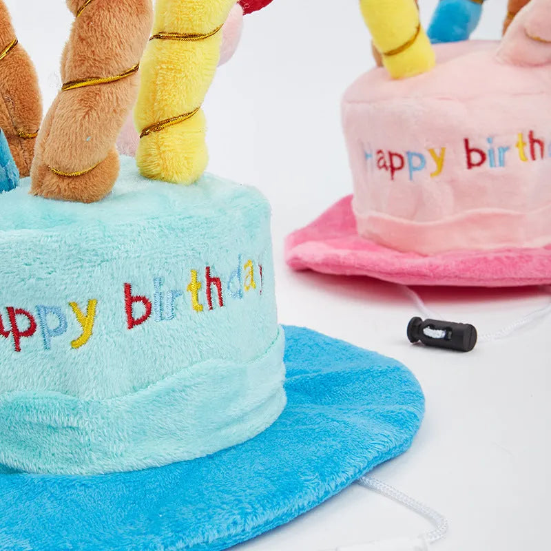 Blue and pink birthday hats for toy dogs on a festive background.