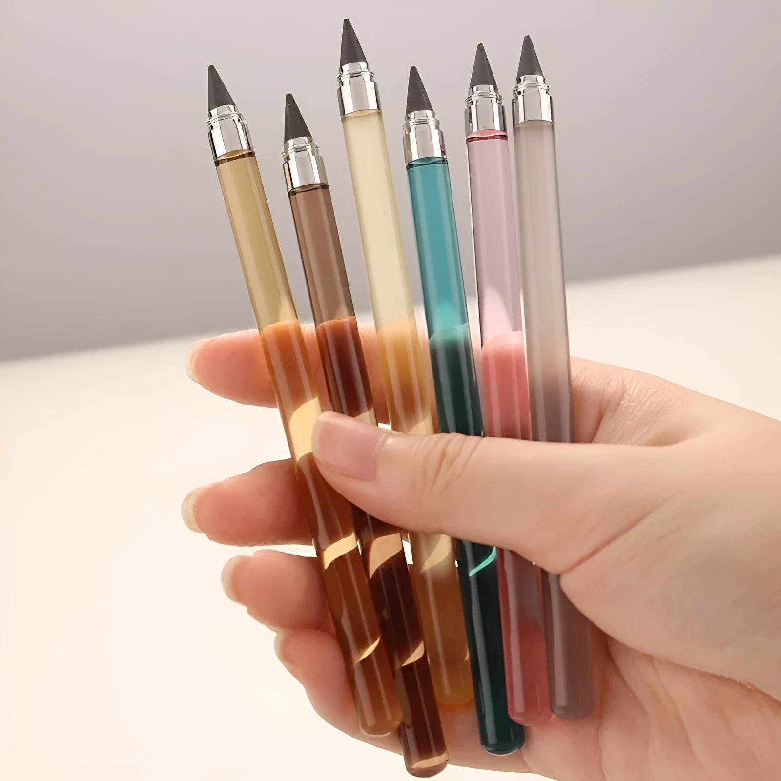 Transparent acrylic eternal mechanical pencil with alloy tip shown in multiple colour options