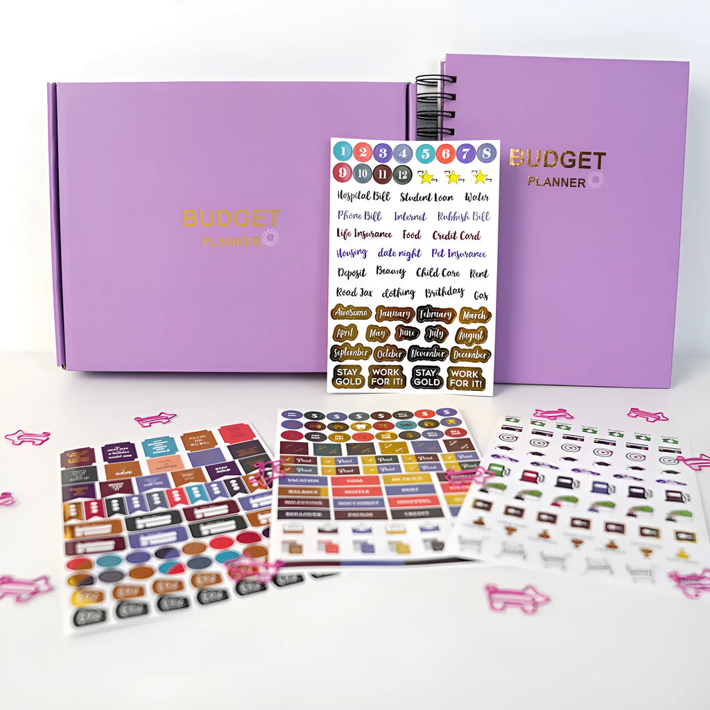 Purple coil-bound budget book set with pen, stickers and paper clips for financial planning