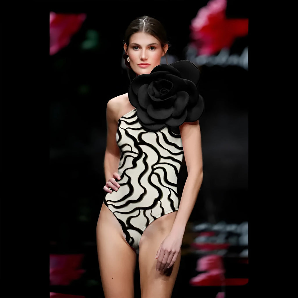 Women's black one-piece swimsuit with three-dimensional white floral pattern, showcasing European/American fit.