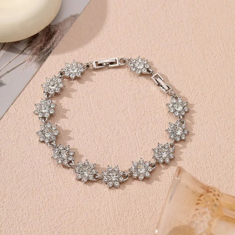 Adjustable zinc alloy bracelet with electroplated flower-shaped links in gold and silver colour options with gemstone accents.