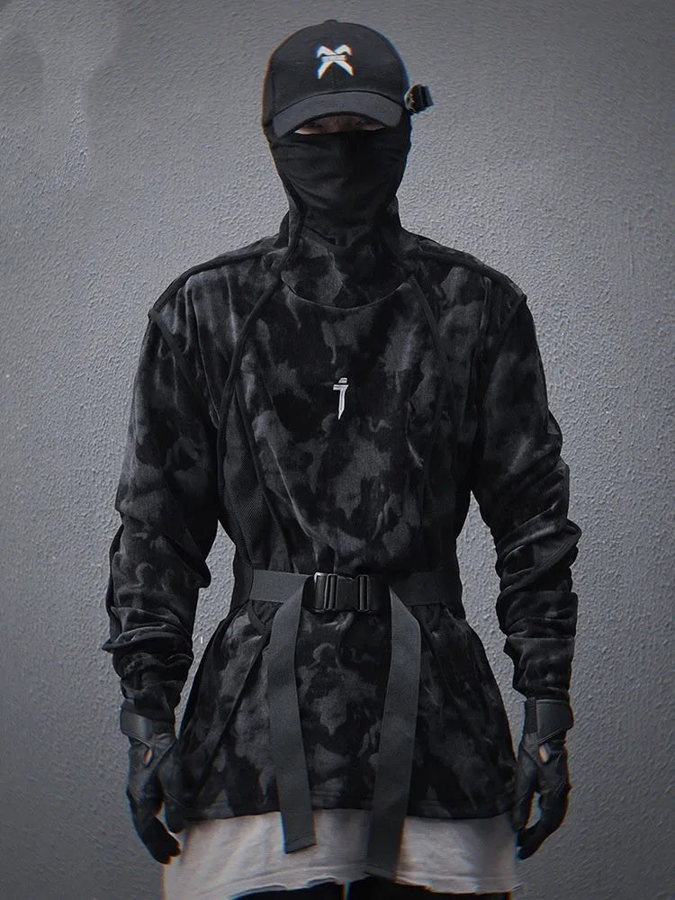 Man wearing a black and grey tie-dye printed sweater with a high finger turtleneck collar and drop shoulders.