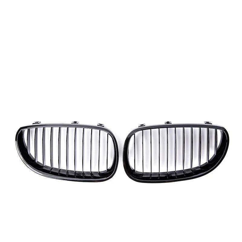 Pair of black carbon fibre pattern front grilles for a BMW 5-Series car.