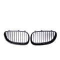 Pair of black carbon fibre pattern front grilles for a BMW 5-Series car.