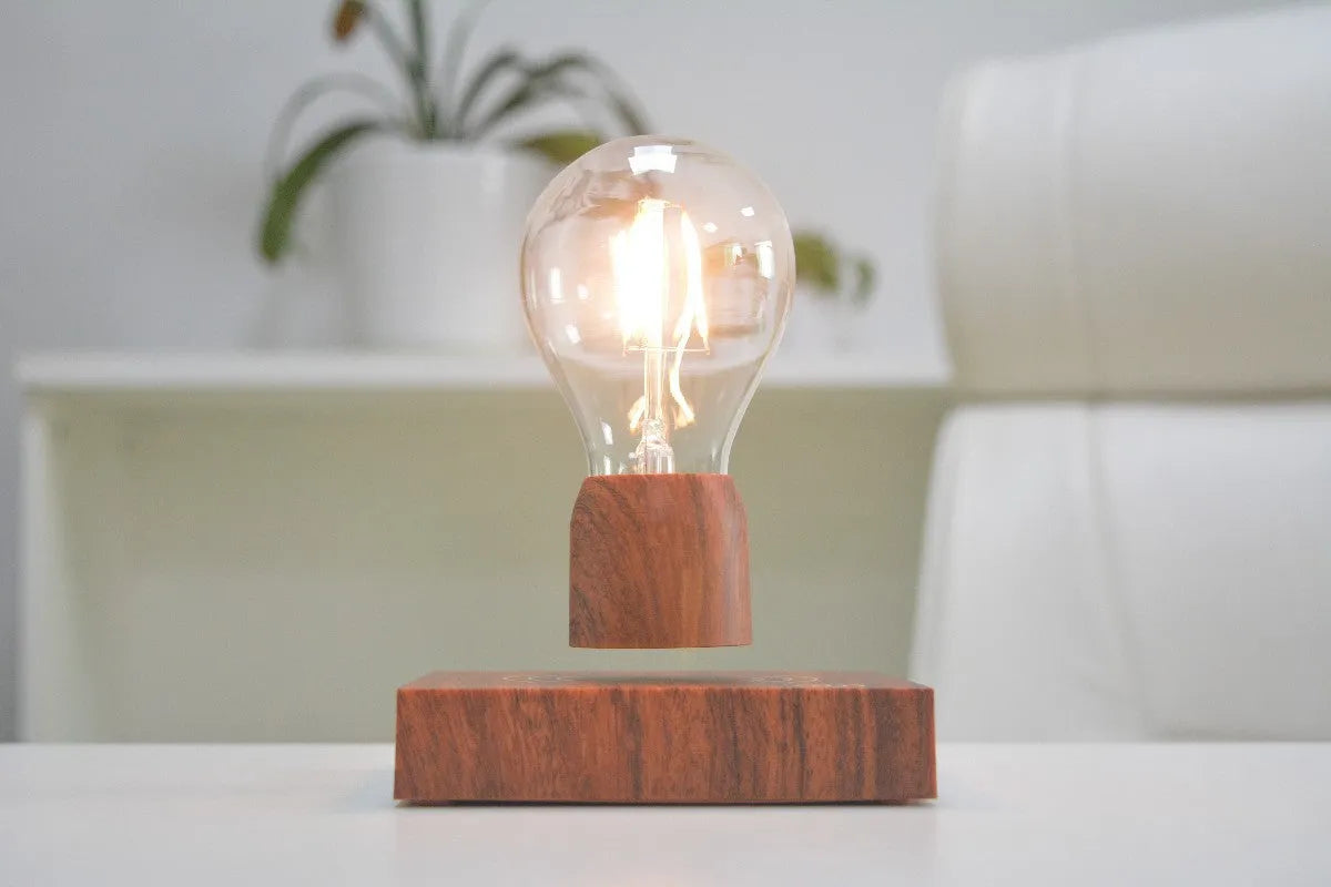 Glass and ABS magnetic levitation bulb floating above an imitation wood base.