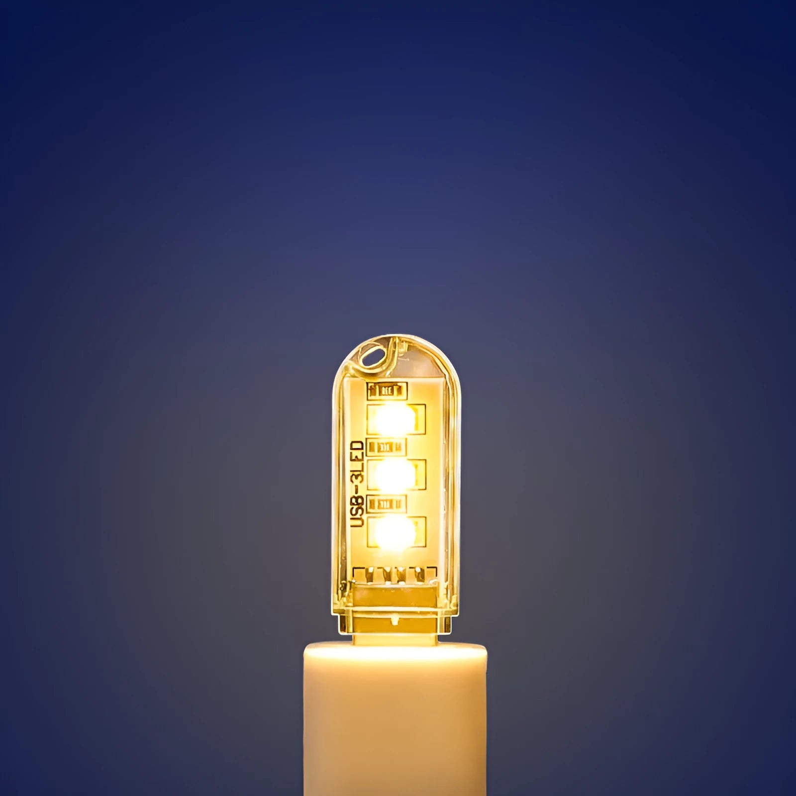 Small white USB-powered LED baby night light with eye protection, shown next to a USB cable for scale.