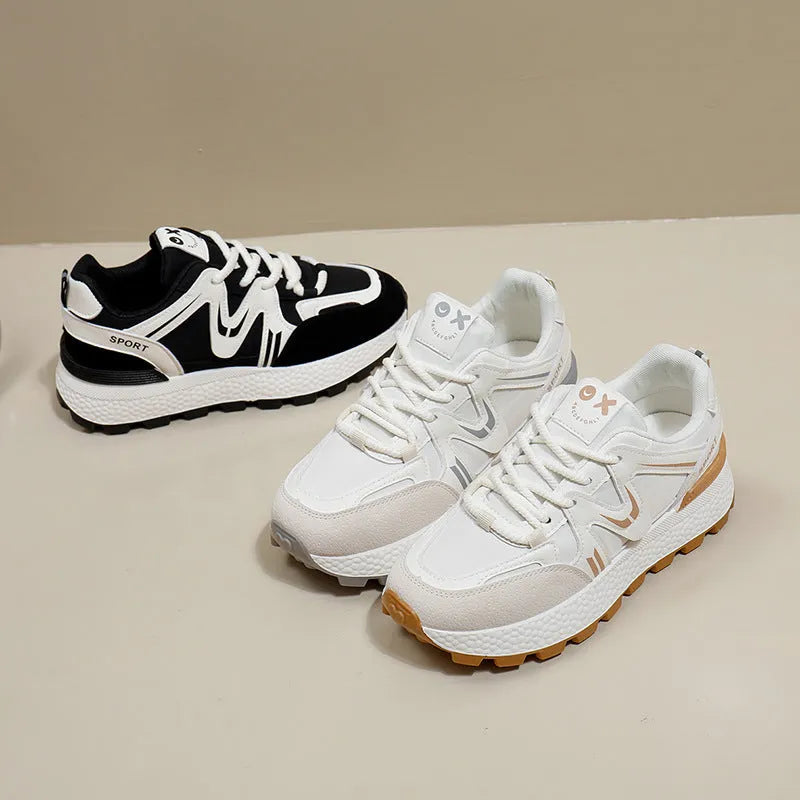 Women's black casual flat shoes with round toe and front lace-up design on a plain background.