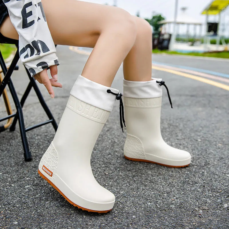 Women's solid colour PVC rain boot in apricot, featuring a non-slip sole and waterproof mouth design.