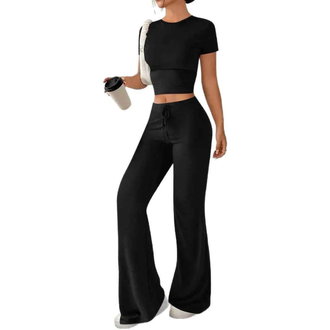Black women's high waist trouser and short sleeve t-shirt co-ord set on a hanger.