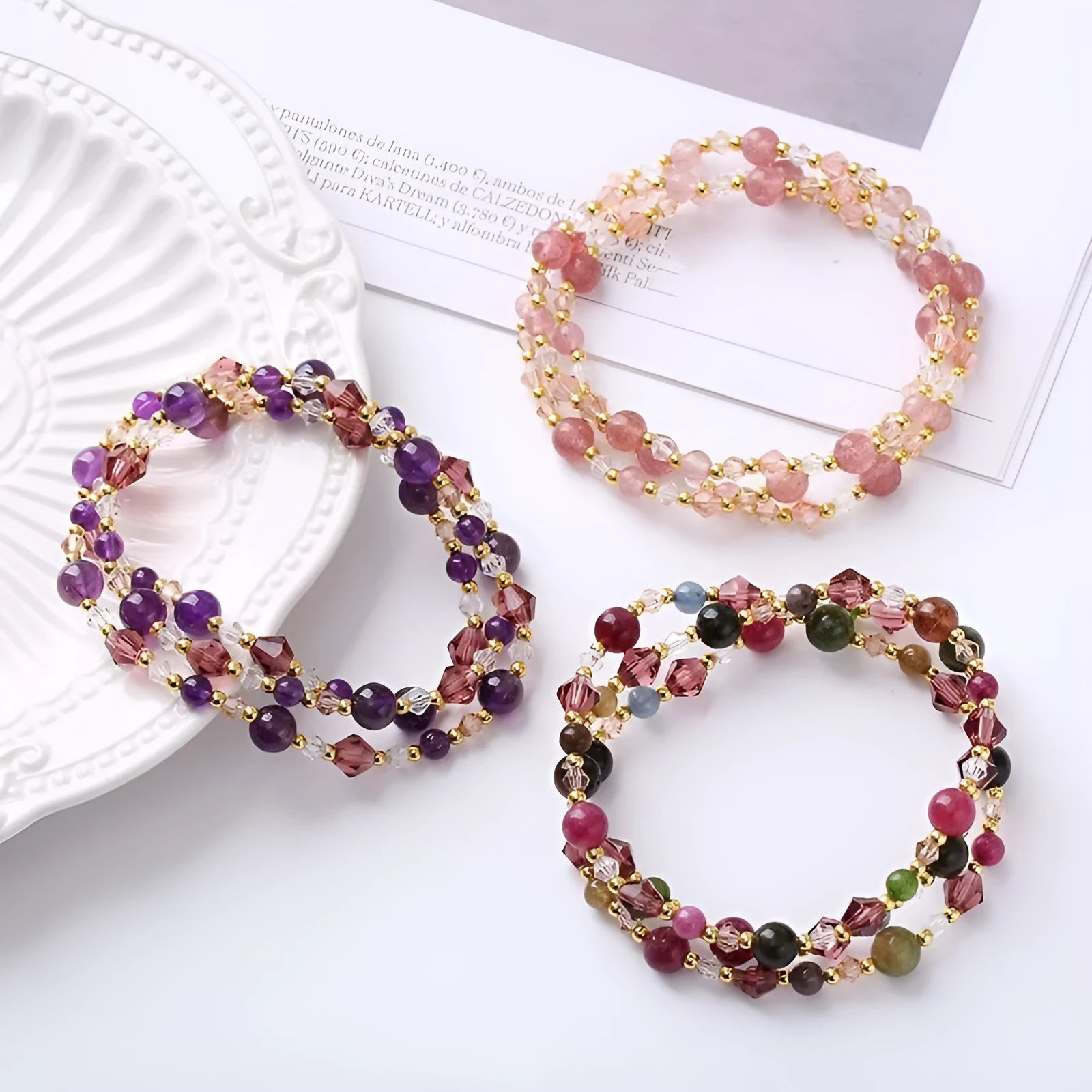 Women's three-ring bracelet with tourmaline, strawberry quartz, and amethyst crystals on an adjustable rope.