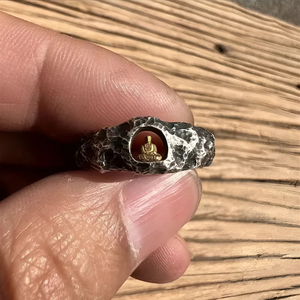 Hand-forged copper Buddha ring with rock texture finish showing grotto design
