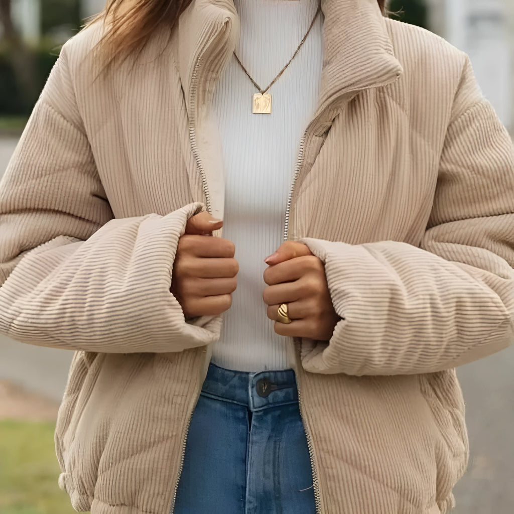Women's apricot corduroy jacket with stand collar and front zip, showing textured fabric detail