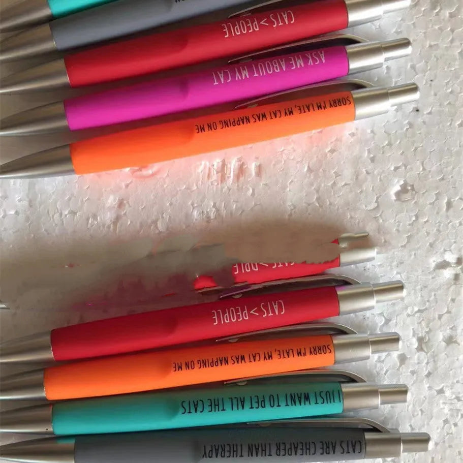 Five automatic push-action pens with animal designs and beaded storage bag