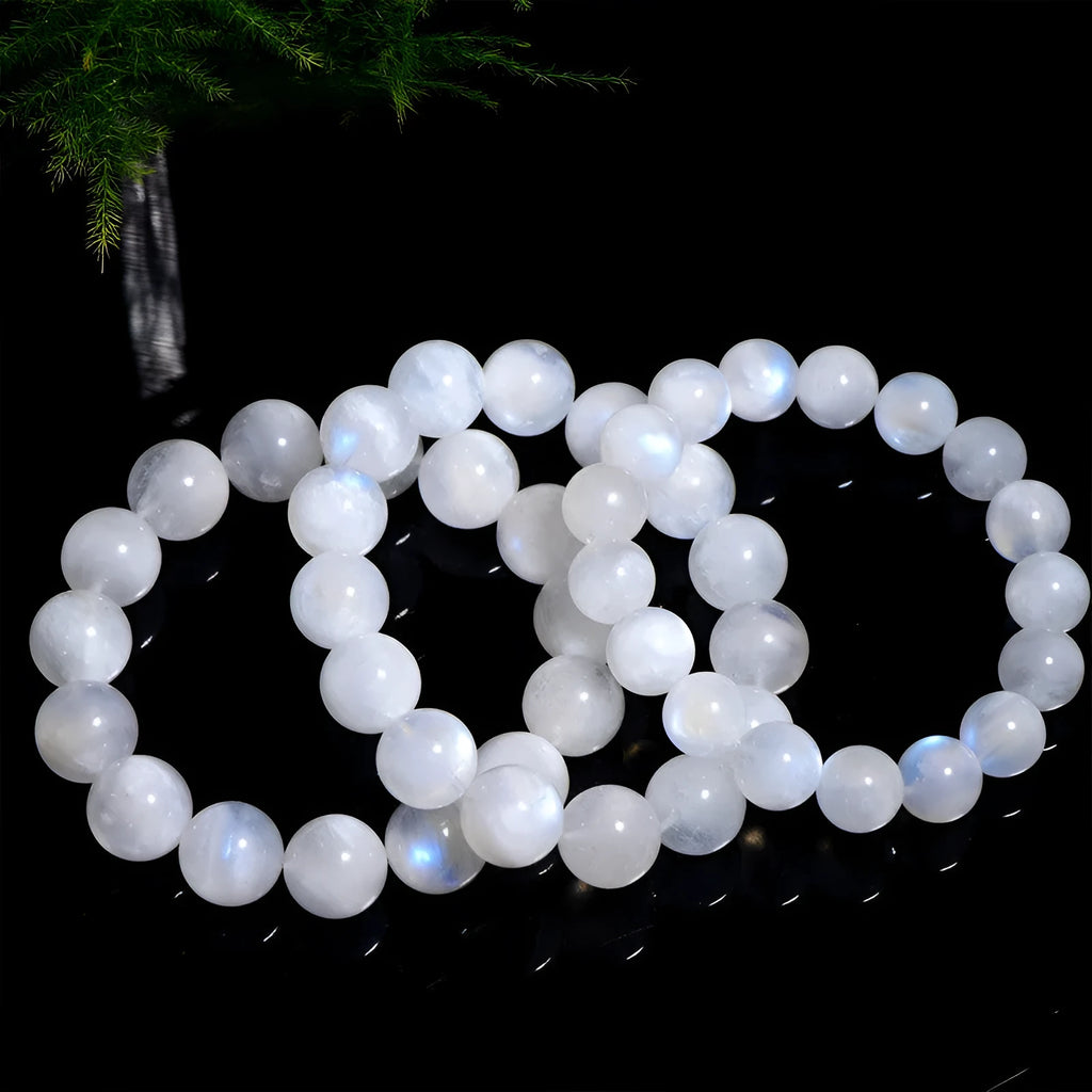 Natural blue moonlight round bead moonstone bracelet showing polished geometric beads on wrist