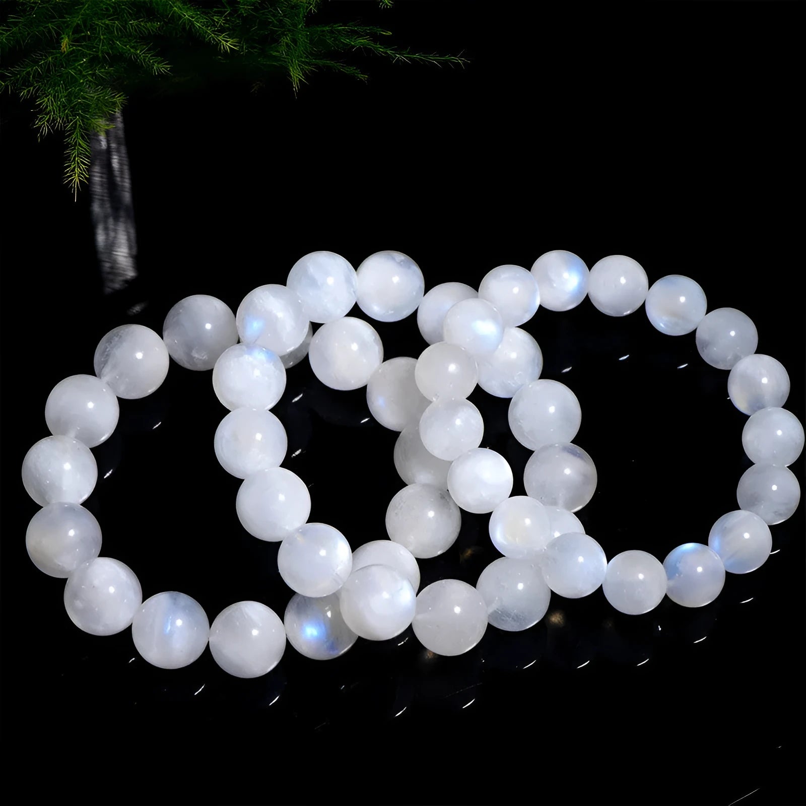 Natural blue moonlight round bead moonstone bracelet showing polished geometric beads on wrist