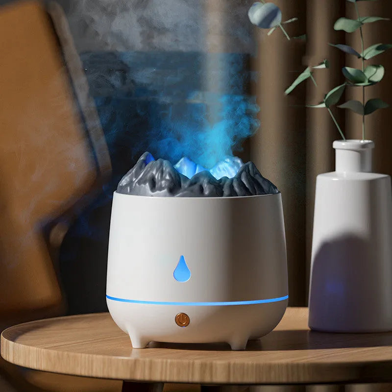 White volcano-shaped ultrasonic humidifier and aromatherapy diffuser on a table.