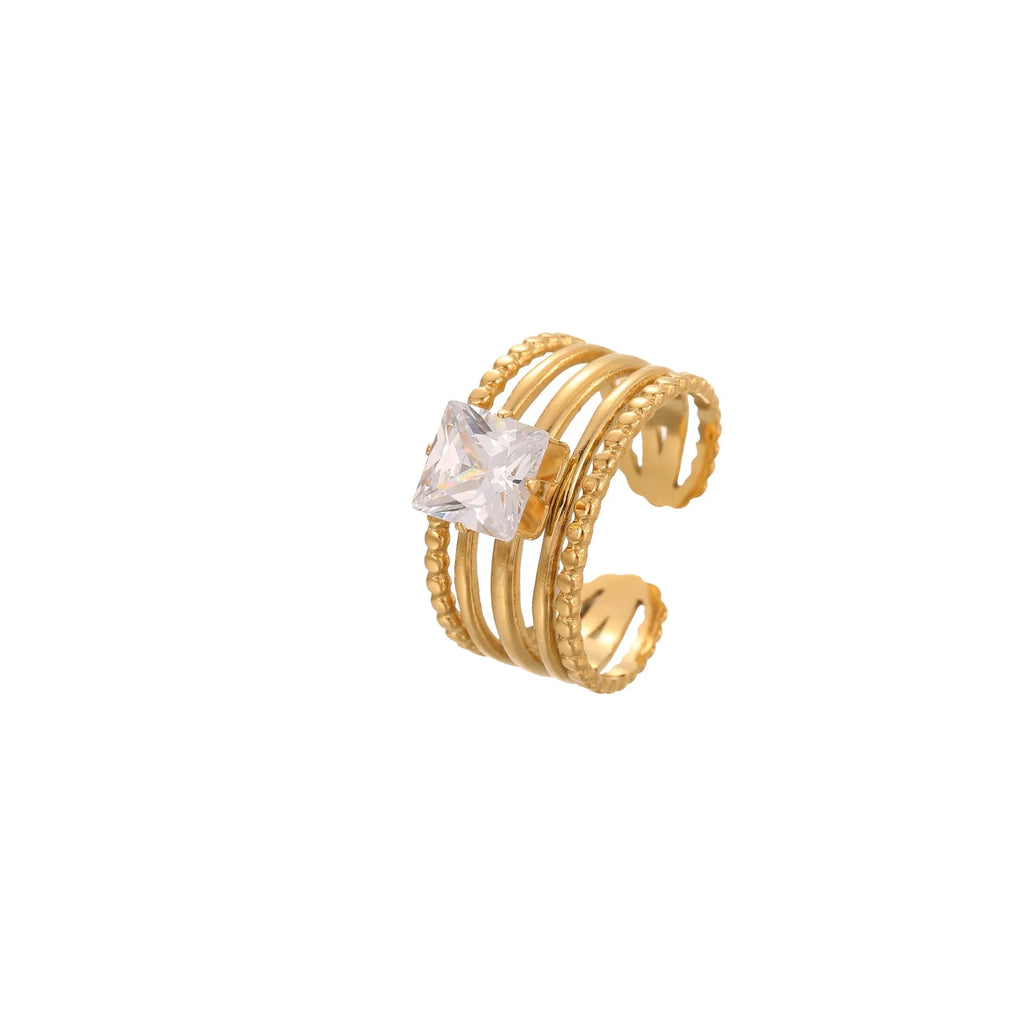 Gold-coloured stainless steel ring with an inlaid zircon stone and geometric heart design on an adjustable open mouth band.