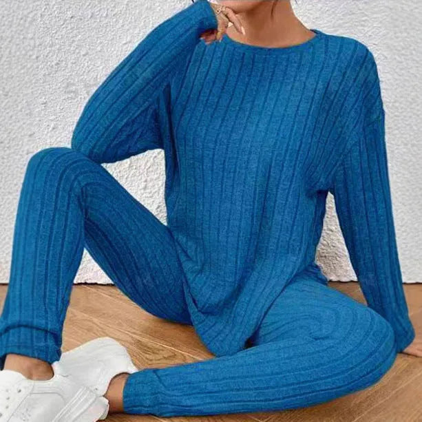 Black sunken stripe polyester two-piece loungewear set with top and pants.