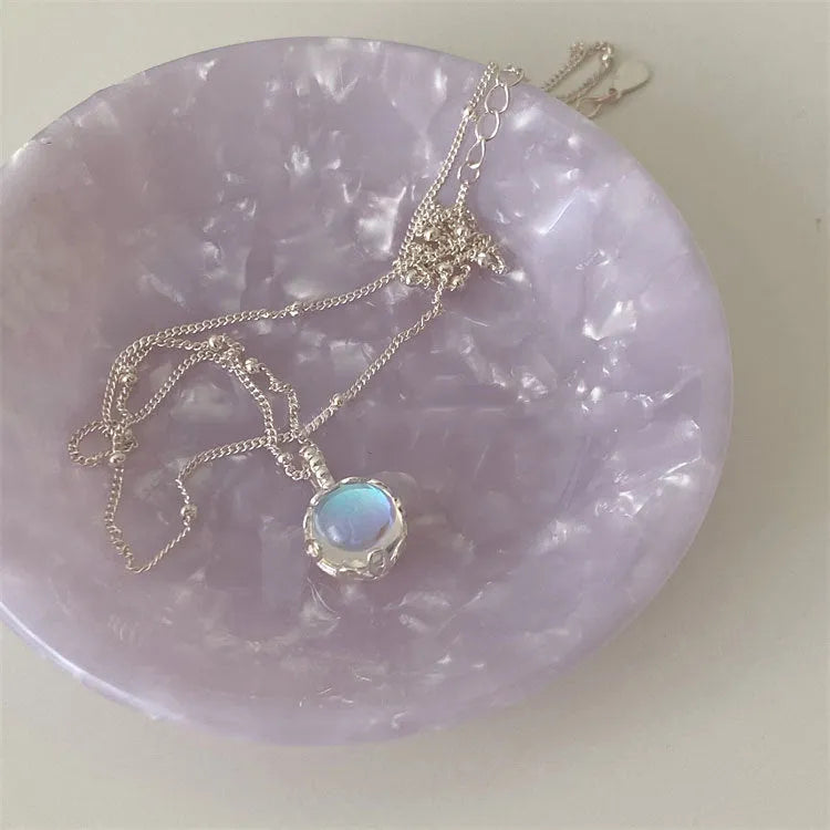 Women's sterling silver necklace with round geometric pendant on an adjustable curb chain.