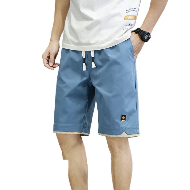 Man wearing green Korean-style loose straight-leg casual beach shorts