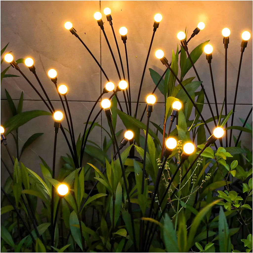 Solar-powered LED garden ground light with multiple LED heads and a stainless steel ground spike.