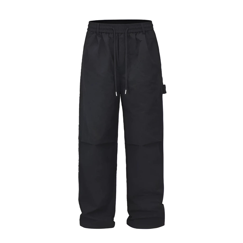 Black baggy paratrooper pants with an elastic drawstring waistband on a mannequin.